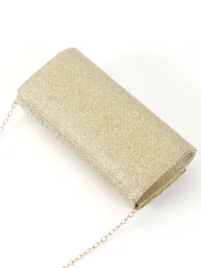 Gold glitter clutch bag detail, stylish evening party accessory with fine chain strap.