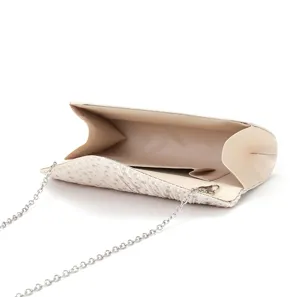 Elegant pleated evening clutch bag detail showing silver chain and smooth interior lining.