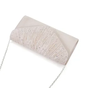 Close-up detail view of the elegant rhinestone pleated evening clutch bag with chic metal chain.