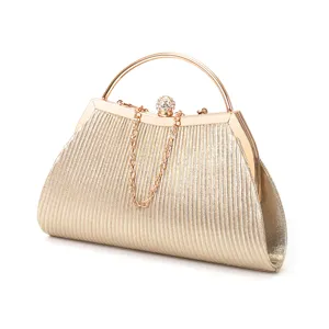Gold pleated clutch bag detail featuring a sparkling rhinestone clasp and elegant metal handle.