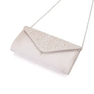 Close up of shimmering champagne satin evening clutch bag with pleated crystal flap and chain.