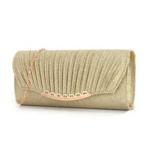 Golden glitter evening clutch bag detail, elegant pleated texture, rose gold chain strap.