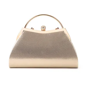 Gold metallic evening clutch bag with sparkling finish, crystal ball clasp and round handle.