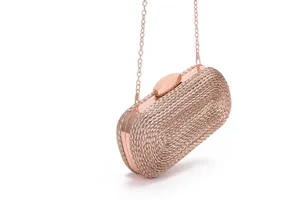 Detailed view of the rose gold woven evening clutch showcasing fine texture and metallic chain.