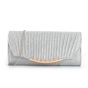 Silver glitter clutch bag with pleated flap design, elegant chain strap and metal clasp detail.
