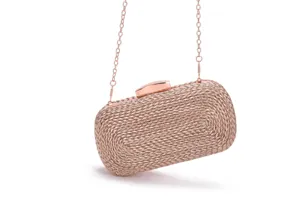 Rose gold woven clutch bag detail, elegant metallic chain strap, sophisticated party accessory.