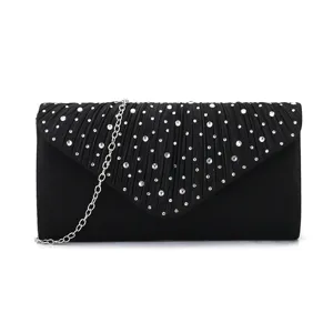 Black evening clutch detail, pleated flap with sparkling rhinestones and silver chain strap.