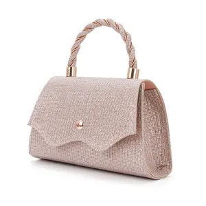 Sparkling glitter evening top handle bag with elegant twisted design and gold hardware detail.