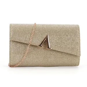 Detailed view of women evening clutch bag, glitter texture and metallic A logo design.