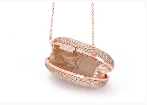 Elegant woven evening clutch bag with rose gold metal frame, rhinestone clasp and chain.