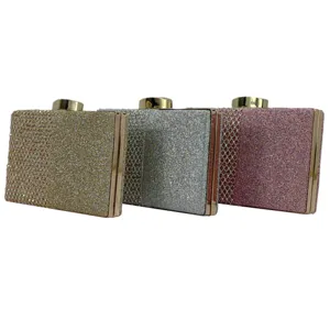 Sparkling rhinestone clutch evening bag with glitter surface and metal frame for party.