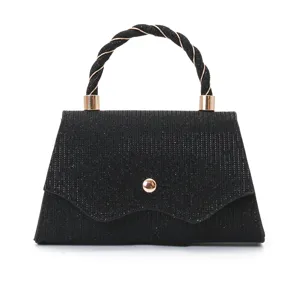 Black glitter evening handbag with twisted handle and gold hardware for wedding party.