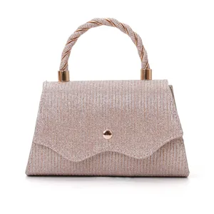 Detailed shot of the sparkling glitter evening handbag showing the unique twisted handle design.