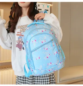 Cute light blue student school backpack with cartoon rabbit pattern, large capacity.