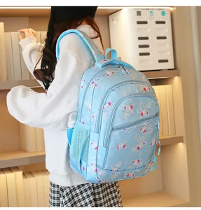 Details of the light blue cute cartoon rabbit printed student backpack with multiple zipper pockets.