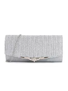 Silver glitter evening clutch bag detail, elegant metallic clasp and chain strap for wedding.