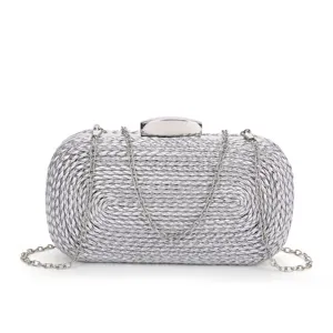 Silver woven metallic clutch bag detail view, elegant evening party handbag texture close-up.