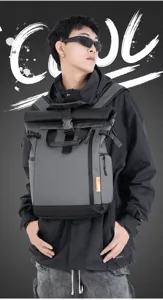 Detail view of water-resistant oxford roll-top backpack with large capacity and dark grey tone.