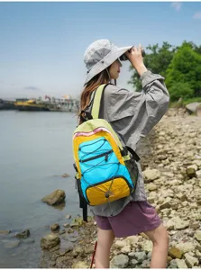 Outdoor travel color-blocking backpack detail view, lightweight hiking daypack with elastic cords.