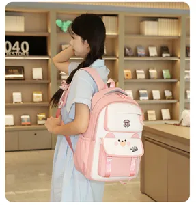 Sac à dos étudiant rose et blanc stylé avec joli design d'ours et grands compartiments.