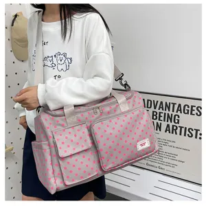 Grand sac de voyage à pois roses, idéal pour les courts séjours et les escapades du week-end.