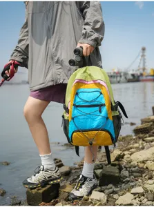 Colorful outdoor travel backpack with multi-color panel design, elastic cord and side mesh pockets.