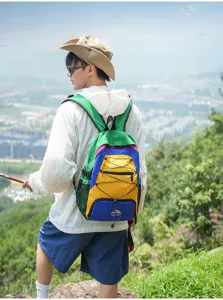 Outdoor travel color-block backpack with multi-color panels, bungee cord, and mesh side pockets.