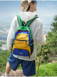 Outdoor travel color block backpack detail showing vibrant multi-color hiking design with cords.