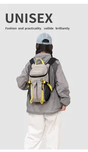 Grey outdoor hiking backpack detail showing yellow straps, mesh side pockets and practical design.