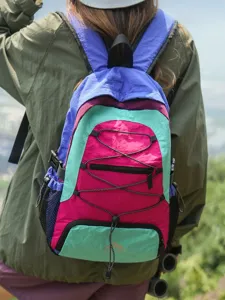 Colorful outdoor travel backpack with vibrant color-blocking, elastic cords, and large capacity.