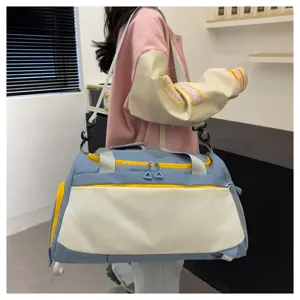 Vue détaillée d'un sac de voyage bleu et blanc avec des fermetures éclair jaunes.