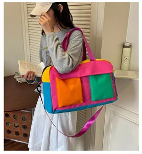Color-blocked travel duffel bag for women, spacious waterproof gym tote with crossbody strap.