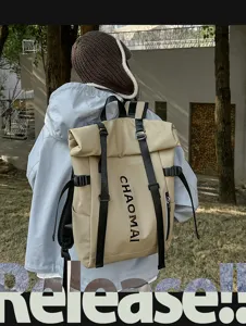 Detail shot of khaki roll-top backpack with black straps and urban style exterior design.
