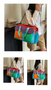 Detailed view of the color-block travel duffel bag with multiple pockets and shoulder strap.
