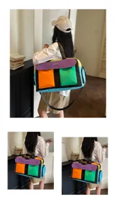 Colorblock canvas travel duffel bag for women, stylish gym shoulder bag and weekend carryall.