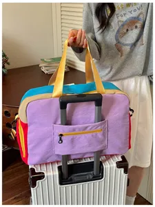 Dopamine color block travel duffel bag with trolley sleeve and handbag straps for women.