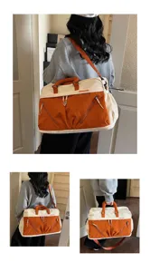 Large capacity travel duffel bag with color block design, shoulder strap and handles for women.
