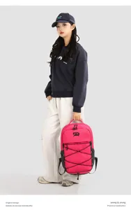 Close-up detail of the vibrant pink outdoor backpack featuring elastic bungee cord and top handle.
