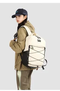 Detail shot of the outdoor sports backpack showing the cream and black bungee cord storage design.