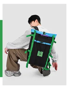 Detailed view of a multi-color block outdoor backpack with bright green straps and large capacity.