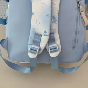 Detailopname van lichtblauwe schooltas achterkant, sterren schouderbanden en stevige gespen.