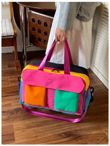 Color-block travel duffel bag detail showcasing multi-color canvas fabric and large capacity