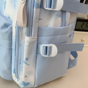 Close-up detail van de lichtblauwe rugzak zijzak, witte gesp en sterrenpatroon voor scholieren.