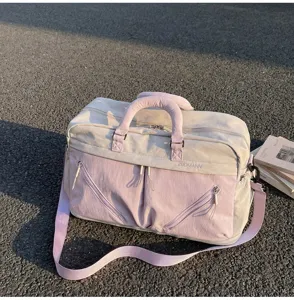 Large capacity travel bag for women, short trip luggage and sports gym bag with stylish pink design.