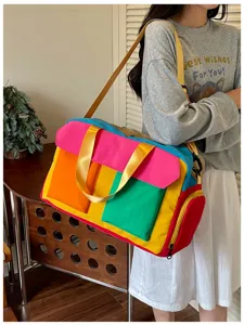 Detailed view of the colorful color-block travel duffel bag showcasing multiple front pockets.