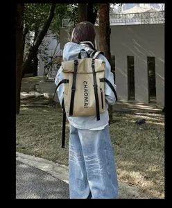 Street fashion waterproof roll top backpack in khaki with black straps for outdoor travel.