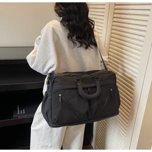 Large capacity black travel duffel bag for women, ideal for weekend trips and sports.