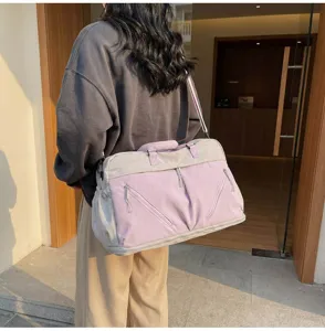 Large capacity travel duffel bag for women, pink and grey expandable luggage and fitness gym bag.