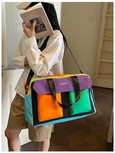 Colorblock travel duffel bag for women, stylish weekend gym shoulder handbag for travel.