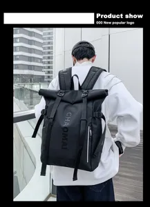 Close-up of black roll-top backpack with straps and zipper pocket in street style.